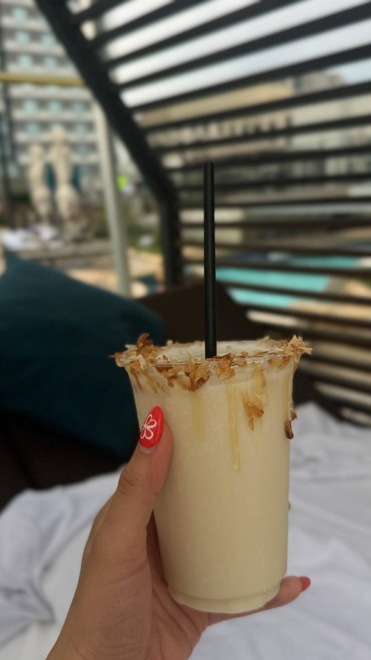 Tasty piña colada by the pool in a very nice daybed. 