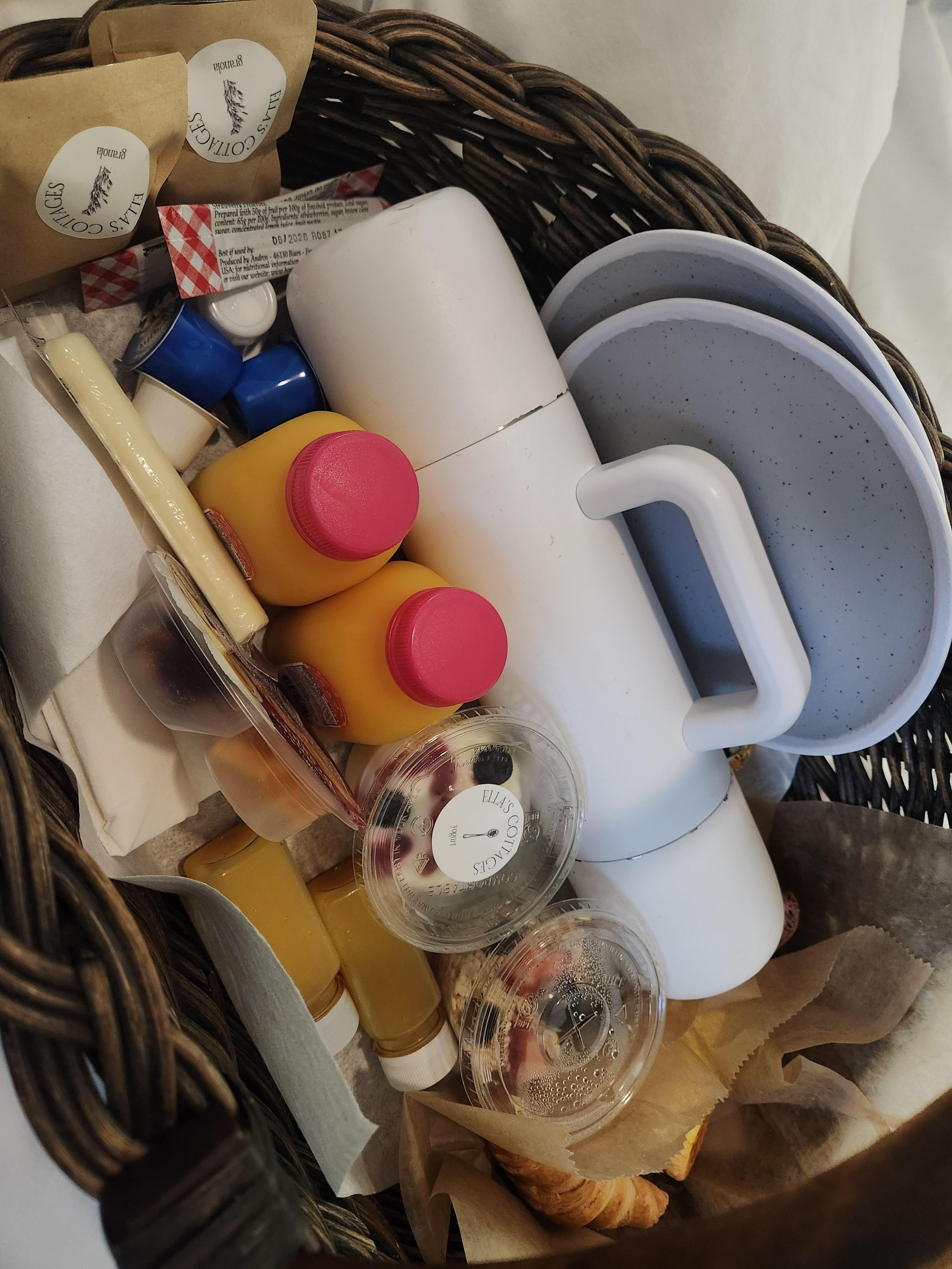 Breakfast Basket: thermos of coffee, 2 bottles of orange juice, 2 turmeric shots, 2 croissants with jam and butter, overnight oats, yogurt+2 packets of granola, 2 chocolate orange biscotti, 2 egg bites, Sargento "balanced break," and string cheese.