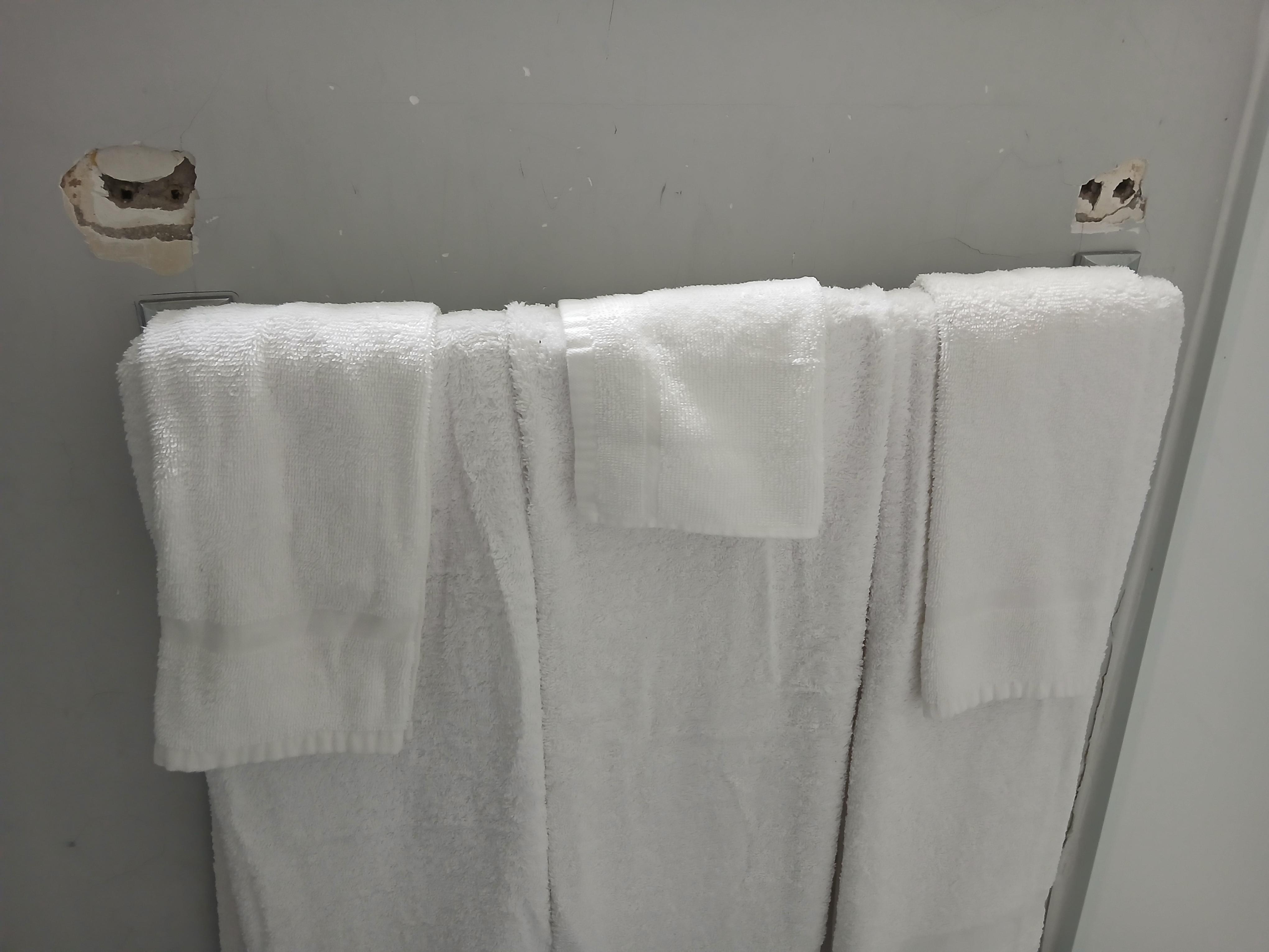 Towel rack had fallen off, left hole and just put it back on below original place.