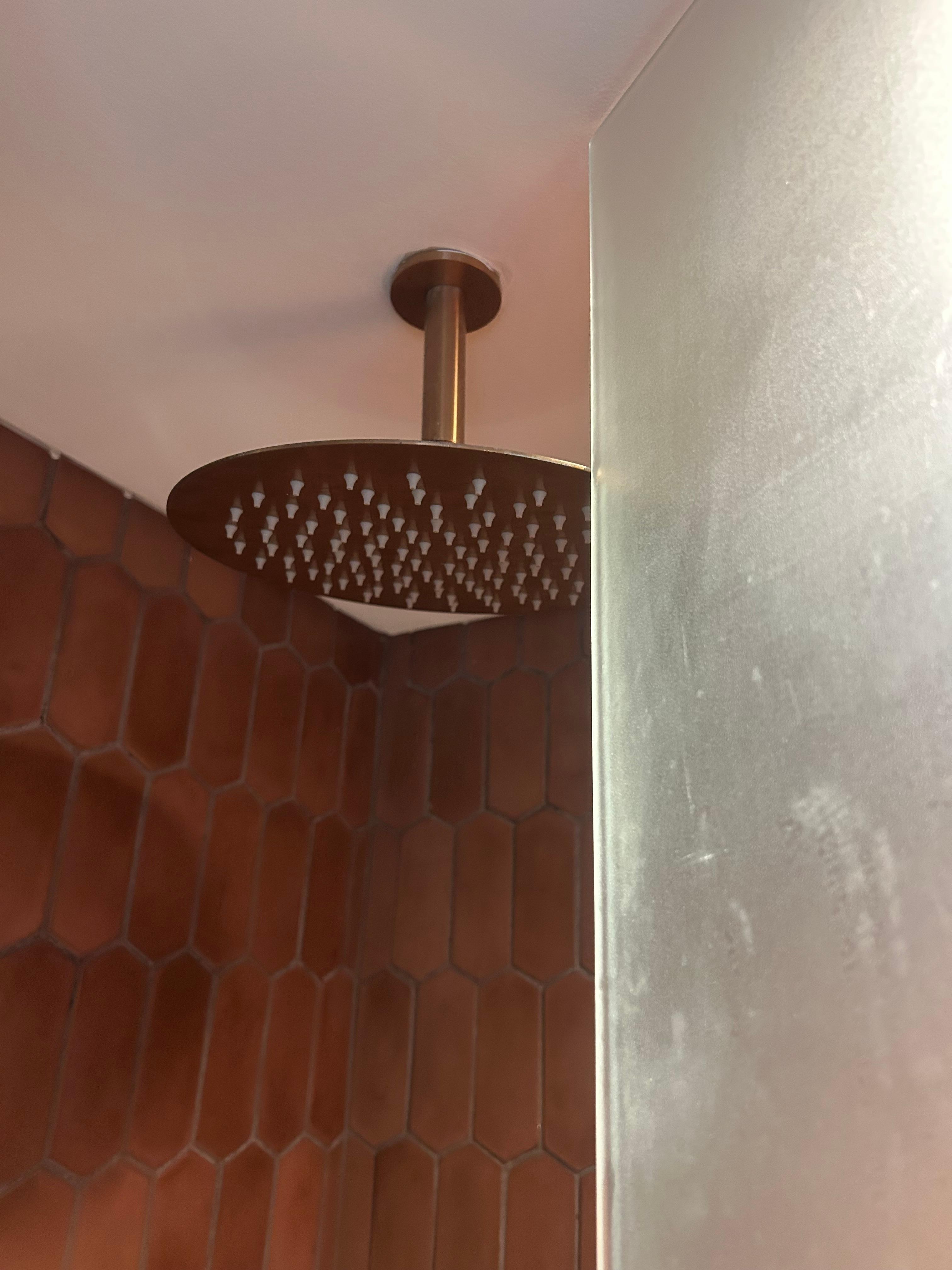 Shower head on the way of the glass door