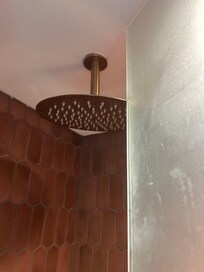 Shower head on the way of the glass door