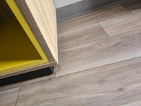 Some kind of filth around the bottom of the cupboard